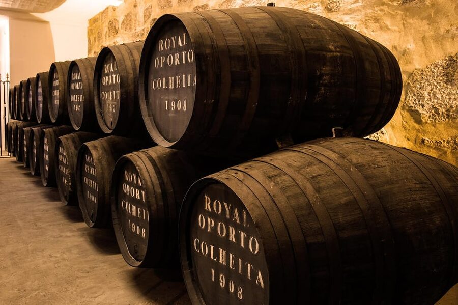Porto: Carvalhas cellar tour at Real Companhia Velha - Entering the Real Companhia Velha cellars: darkness, silence, and old wood